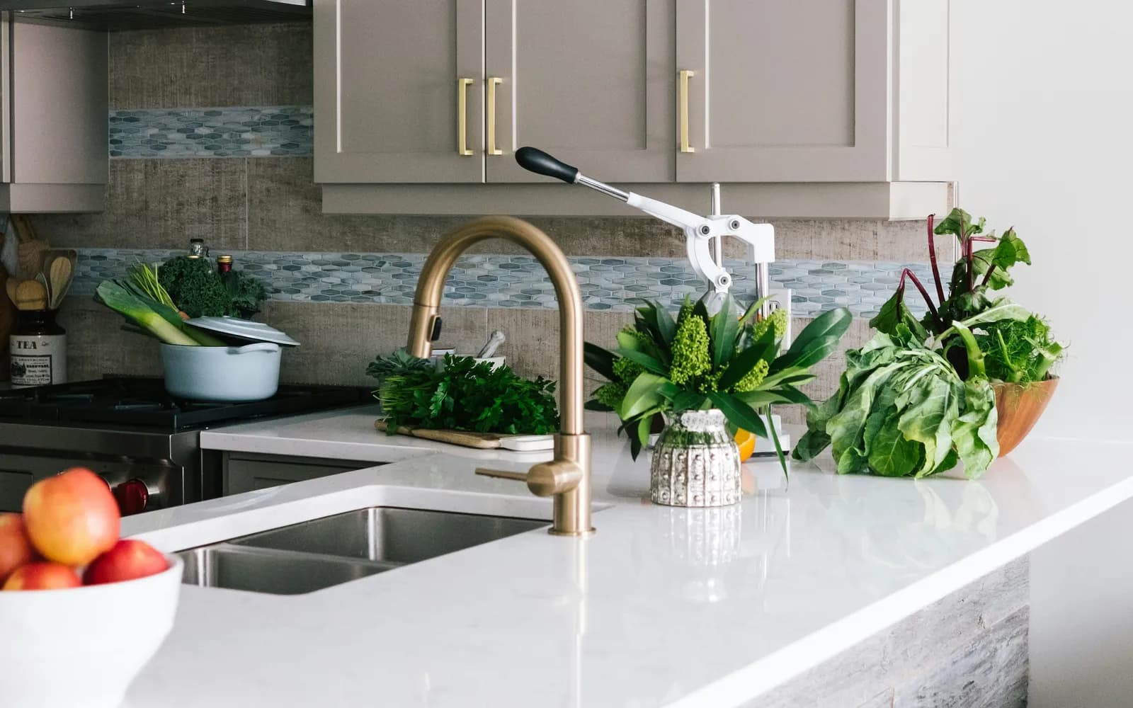 Kitchen cabinets and a sink beside a tiled backsplash