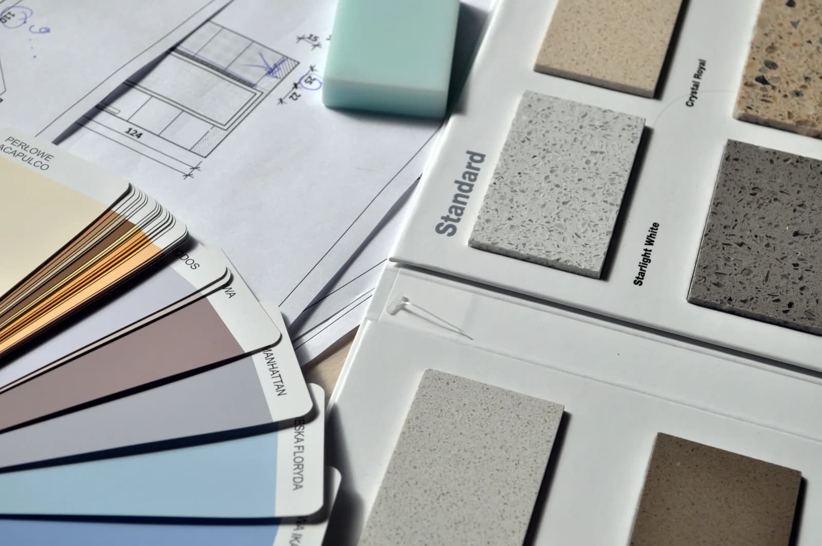 Colour swatches and surface material samples beside a renovation drawing